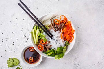 Canvas Print - Bun cha salad bowl. Vietnamese rice noodle with beef and chilli vegetables salad in white bowl, copy space.