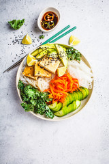 Wall Mural - Vietnamese rice noodle with grilled tofu and  chilli vegetables salad in white bowl, top view.