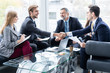 © opolja - Business people shaking hands, finishing up a meeting. Handshake. Business concept.