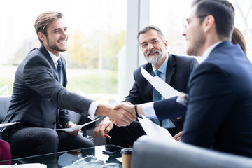 Business people shaking hands, finishing up a meeting. Handshake. Business concept.