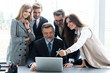 © opolja - Image of business partners discussing documents and ideas at meeting.