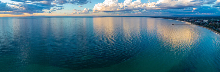 Wall Mural - Mornington Peninsula coastline and Port Phillip Bay at sunset with beautiful cloud reflections - wide aerial panorama