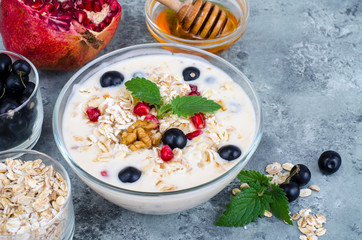 Wall Mural - Healthy delicious muesli with oatmeal and pomegranat