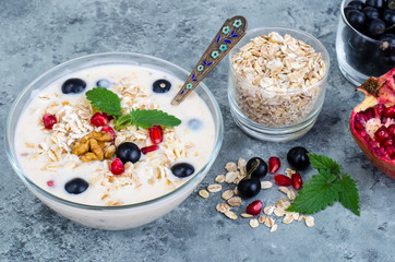 Wall Mural - Healthy delicious muesli with oatmeal and pomegranat