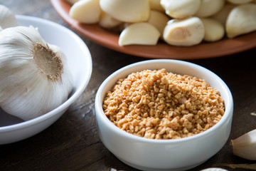 Garlic in a bowl and peeled garlic in dish. Fried garlic