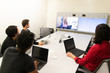 © Mat Hayward - group of business people working in office including remote work on video