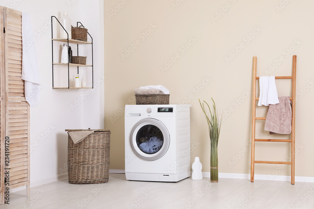 Laundry room interior with washing machine near wall - obrazy, fototapety, plakaty 