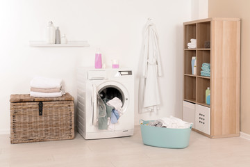 Wall Mural - Washing machine with dirty clothes and towels in laundry room