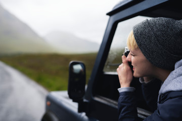 Poster - Woman taking a photo out of the car window