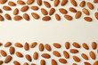 Composition with organic almond nuts and space for text on light background, top view