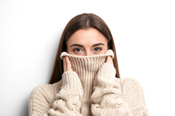 Sticker - Beautiful young woman in warm sweater on white background