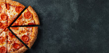Tasty Pepperoni Pizza And Cooking Ingredients Tomatoes Basil On Black Concrete Background. Top View Of Hot Pepperoni Pizza. With Copy Space For Text. Flat Lay. Banner
