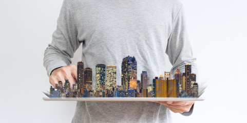 Poster - a man using digital tablet with modern buildings hologram. Real estate business and investment, building technology