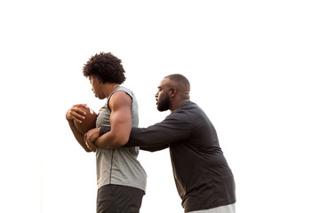 Wall Mural - American Football coach training a young athlete.