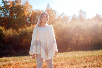 Poster - Pretty girl posing on camera and enjoying sunny autumn day.