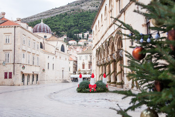 Wall Mural - Christmas tree and street decoration in old town of Dubrovnik, Croatia. Amazing ancient architecture, cathedral, square. Authentic festive atmosphere.