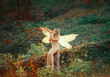 lovely girl druid with blond long hair, sits on a fallen tree, dressed in a gorgeous beige dress with open sexy slim legs, transforming into a light forest butterfly, flashing on a wooden pipe alone