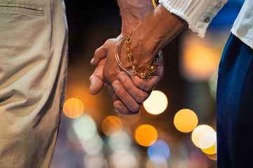 Couple holding hand at night