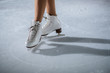 © StockVideoFactory - White skates on the ice. A young dancer is having her performance.