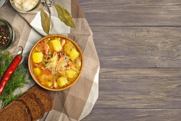 Wall Mural - Soup with sauerkraut  prepared with potato, carrot and  served in a bowl.