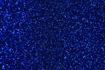 Dark blue sparkling background from small sequins, closeup. Brilliant backdrop