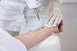 © uv_group - Cosmetologist doing laser tattoo removal from woman hand in cosmetology clinic