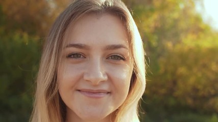 Poster - Close-up shot of smiling woman enjoying nature in autumn season.