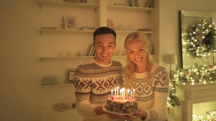 Poster - The happy parents giving cake with candles to a girl. slow motion