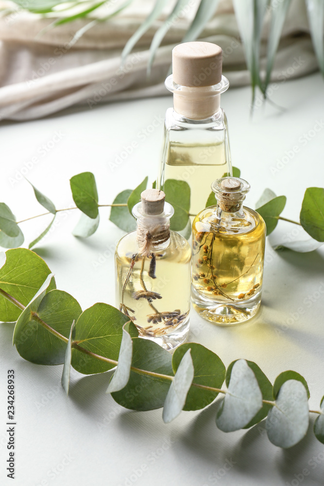 Bottles of eucalyptus essential oil on table