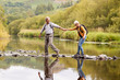 © Monkey Business - Senior Couple Crossing River Whilst Hiking In UK Lake District