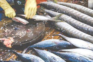 Wall Mural - Street Vendor in Cat Ba Island, Vietnam traditional fish market people selling fresh fish on the sidewalk.