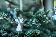Figure Of Pink Angel With Dove In His Hands On A Branch Of Spruce, Glass Christmas Decoration, Background With Copy Space