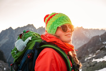 female tourist hiking at high tatras at gold sunset, slovakia