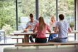 © Monkey Business - Multi ethnic group of four young adult friends talking and eating meal during a dinner party