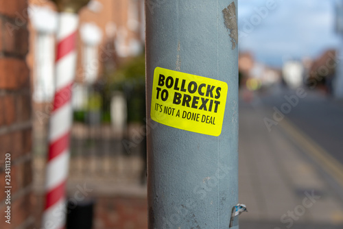 yellow bollocks to brexit its not a done deal sign on lampost with blurred urban background