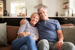 © Monkey Business - Senior white couple relaxing at home smiling to camera