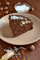 Wall Mural - Chocolate-beet cake, decorated with hazelnut and coconut chips, vertical 