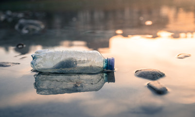 Environmental pollution: plastic bottle on the beach