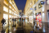 Fototapeta Londyn - crowd of people walking on the night rainy streets in the city 