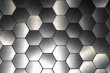 Modern background with a metal hexagons and a black outline. Macro shot