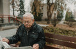 © ADDICTIVE STOCK - Elderly man reading newspaper in park