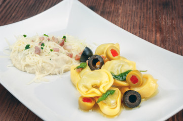 Tortellini with cheese sauce and olive