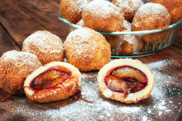 Plum dumplings on wooden table