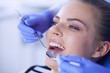 © lenets_tan - Young Female patient with open mouth examining dental inspection at dentist office.