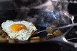 © Lori Eanes - Eggs and potatoes cooking on a pan