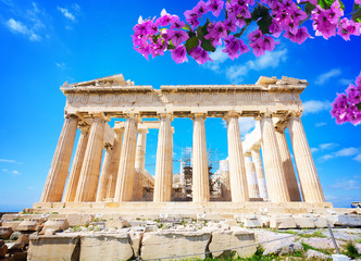 Fotomurales - facade of Parthenon temple over bright blue sky background with flowers, Acropolis hill, Athens Greece