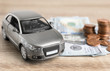 © New Africa - Toy car and money on table. Vehicle insurance