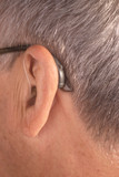 Fototapeta Konie - Deaf man hearing aid ear