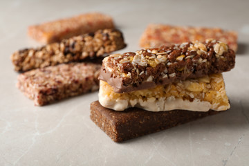 Tasty protein bars on grey table. Space for text