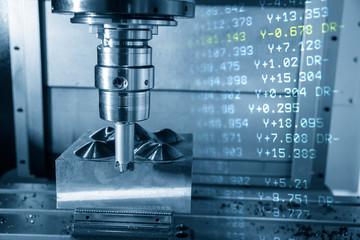 The  abstract scene of CNC milling machine and NC data.The CNC milling machine cutting the mold part with the index-able radius end mill tool in roughing process.